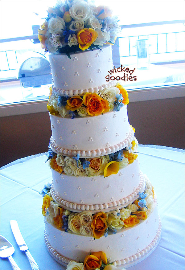 Classic White Wedding Cake with Raised Tiers and Fresh Flowers