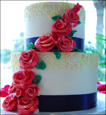 White Wedding Cake with Red Flowers